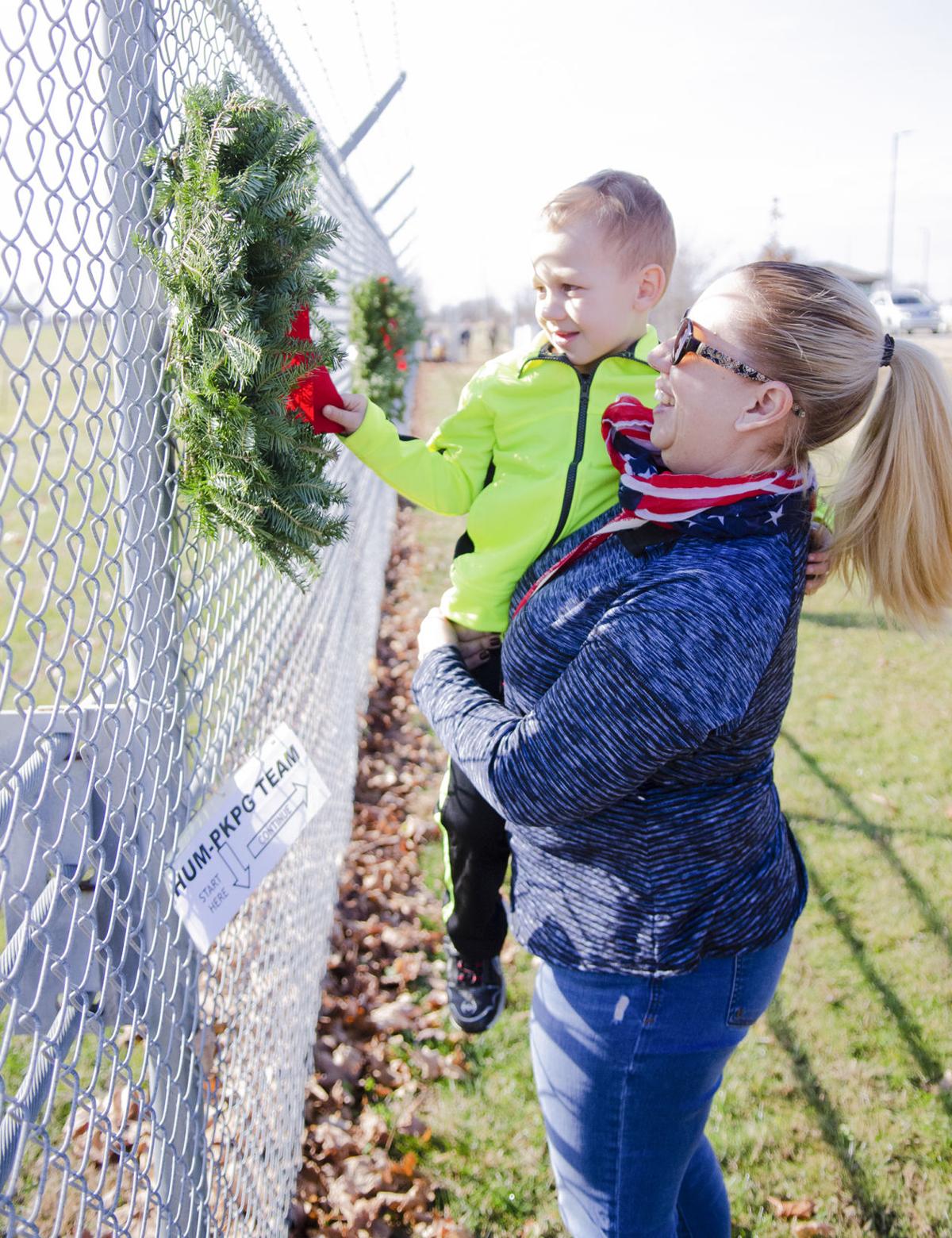 Honoring fallen – Volunteers hang 101 wreaths on post